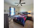 Bedroom with ceiling fan, window, and bed with superhero-themed bedding at 3301 Bethpage Loop, Mount Dora, FL 32757