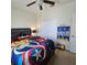 Bedroom with ceiling fan, closet, and bed with superhero-themed bedding at 3301 Bethpage Loop, Mount Dora, FL 32757