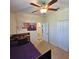 Bedroom features a ceiling fan, closet and a door that leads to a hallway at 3301 Bethpage Loop, Mount Dora, FL 32757