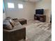 Upstairs bonus room features modern wood-look flooring, a large television, and a comfortable sectional sofa at 3301 Bethpage Loop, Mount Dora, FL 32757