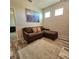 Cozy bonus room with a comfortable brown sectional sofa, a large picture, and modern wood floors at 3301 Bethpage Loop, Mount Dora, FL 32757