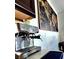 Elegant coffee station featuring a stainless steel machine and world map wall art at 3301 Bethpage Loop, Mount Dora, FL 32757