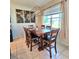 Dining room with a wooden table, six chairs, and a window with curtains at 3301 Bethpage Loop, Mount Dora, FL 32757
