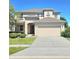 Spacious two-story home featuring a two-car garage and a well-manicured front yard at 3301 Bethpage Loop, Mount Dora, FL 32757