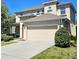 Two-story home with a neutral color scheme, a driveway, and a two-car garage at 3301 Bethpage Loop, Mount Dora, FL 32757