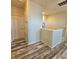 Hallway features wood-look flooring and a door leading to other parts of the house at 3301 Bethpage Loop, Mount Dora, FL 32757