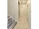 Bright hallway with tile flooring and white doors at 3301 Bethpage Loop, Mount Dora, FL 32757