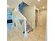 Bright hallway with tile flooring and decorative wall next to staircase at 3301 Bethpage Loop, Mount Dora, FL 32757