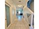Bright hallway with tile flooring, decorative wall, and a view to living area at 3301 Bethpage Loop, Mount Dora, FL 32757