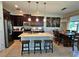 Open kitchen and dining area with a large island and barstool seating at 3301 Bethpage Loop, Mount Dora, FL 32757