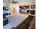 Spacious living room and kitchen combination featuring tile floors, a modern fireplace, and a large island at 3301 Bethpage Loop, Mount Dora, FL 32757