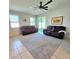 Bright living room with neutral walls, tile floors, and two couches at 3301 Bethpage Loop, Mount Dora, FL 32757