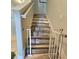 A wooden staircase featuring modern wood treads and white trim, with a safety gate installed at 3301 Bethpage Loop, Mount Dora, FL 32757