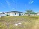 Spacious backyard featuring a white fence, lush green grass, and beautiful mature tree at 332 Blue Lake Cir, Kissimmee, FL 34758