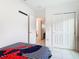 Bedroom showing closet space, doorway, and striped bedding at 332 Blue Lake Cir, Kissimmee, FL 34758