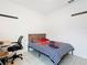 Neat bedroom with striped bedding, a small desk, and hooks for storage at 332 Blue Lake Cir, Kissimmee, FL 34758