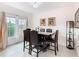 Elegant dining room with a dark wood table, leather chairs, and modern decor at 332 Blue Lake Cir, Kissimmee, FL 34758