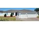 Charming single-story home with a two-car garage and well-maintained landscaping at 332 Blue Lake Cir, Kissimmee, FL 34758