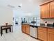 Spacious kitchen open to living areas, featuring granite countertops and stainless steel appliances at 332 Blue Lake Cir, Kissimmee, FL 34758