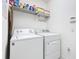 Laundry room featuring a washing machine, dryer, and upper cabinet storage at 332 Blue Lake Cir, Kissimmee, FL 34758