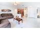 Open-concept living area featuring tile floors, a kitchen bar and a casual seating area at 332 Blue Lake Cir, Kissimmee, FL 34758