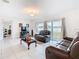 Comfortable living room with leather seating, sliding glass doors and plenty of natural light at 332 Blue Lake Cir, Kissimmee, FL 34758