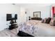 The main bedroom offers wood-look floors, furniture and decor with ensuite bathroom and closet access at 332 Blue Lake Cir, Kissimmee, FL 34758