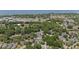 Scenic aerial view of a residential area with tree coverage and pond, near community buildings and recreational fields at 336 Sunset Oaks Rd, Winter Garden, FL 34787