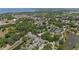 Scenic aerial view showcasing a residential area with lush trees, ponds, and houses near a large lake at 336 Sunset Oaks Rd, Winter Garden, FL 34787