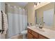 Cozy bathroom featuring a vanity with a granite countertop, a shower, and modern fixtures at 336 Sunset Oaks Rd, Winter Garden, FL 34787