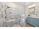 Modern bathroom showcasing a tiled walk-in shower with a built-in bench, complemented by a stylish vanity with marble countertop at 336 Sunset Oaks Rd, Winter Garden, FL 34787