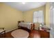 Bright bedroom with hardwood floors, a comfortable single bed, and a window with natural light at 336 Sunset Oaks Rd, Winter Garden, FL 34787