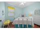 Serene bedroom featuring wood floors, white furniture, and a window with bright yellow accents at 336 Sunset Oaks Rd, Winter Garden, FL 34787