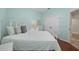 Bright bedroom with a white iron bed, wooden floors, and a double door closet at 336 Sunset Oaks Rd, Winter Garden, FL 34787