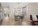 Dining area featuring a wooden table, four chairs, a hanging light fixture, and views to the kitchen at 336 Sunset Oaks Rd, Winter Garden, FL 34787