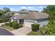 Aerial view of home featuring a two-car garage, well-maintained landscaping, and private screened lanai at 336 Sunset Oaks Rd, Winter Garden, FL 34787