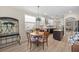 Bright eat-in kitchen has wood floors, stainless appliances, and a decorative light fixture over the breakfast table at 336 Sunset Oaks Rd, Winter Garden, FL 34787