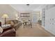 Bright living room featuring neutral tones, wood floors, and built-in shelving and a decorative entry way at 336 Sunset Oaks Rd, Winter Garden, FL 34787