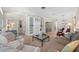 Cozy living room showcasing wood floors, built-in shelving, neutral furniture, and views to the dining room at 336 Sunset Oaks Rd, Winter Garden, FL 34787