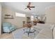 Bright living room featuring a ceiling fan, cozy furniture, and an open floor plan leading into the kitchen at 336 Sunset Oaks Rd, Winter Garden, FL 34787