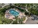 Aerial view of the community pool, featuring lounge chairs and lush tropical landscaping at 336 Sunset Oaks Rd, Winter Garden, FL 34787