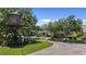 Street view of well-maintained homes in a neighborhood with mature trees and landscaping under a blue sky at 336 Sunset Oaks Rd, Winter Garden, FL 34787