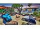 Backyard with an outdoor kitchen, a fire pit, and comfortable seating areas at 340 Zelda Blvd, Daytona Beach, FL 32118