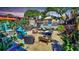 Backyard haven featuring an outdoor kitchen, stylish seating around a fire pit, and lush tropical plants at 340 Zelda Blvd, Daytona Beach, FL 32118