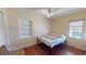 Bright bedroom with hardwood floors, a colorful quilt, and a built-in bookshelf at 340 Zelda Blvd, Daytona Beach, FL 32118