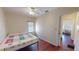 Simple bedroom with hardwood floors, a colorful quilt, and a large window at 340 Zelda Blvd, Daytona Beach, FL 32118
