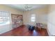 Empty bedroom with hardwood floors, natural light, and a large art piece at 340 Zelda Blvd, Daytona Beach, FL 32118