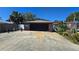 Garage exterior displaying a brick facade with a spacious driveway, offering ample parking at 340 Zelda Blvd, Daytona Beach, FL 32118