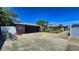 Detached garage with a long driveway offering ample parking and storage, and a side yard at 340 Zelda Blvd, Daytona Beach, FL 32118