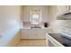 Traditional kitchen featuring white cabinets, tile floors, and updated appliances at 340 Zelda Blvd, Daytona Beach, FL 32118